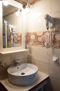 a bathroom with a sink and a mirror at angelikashouse,big house in Corfu Town