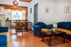 a living room with a blue couch and a table at angelikashouse,big house in Corfu Town +24 photos