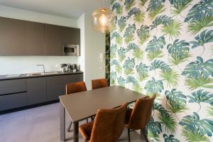 a kitchen and dining room with a table and chairs at AlbaResidence Vico01 in Alba