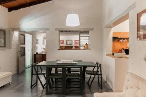 a dining room with a black table and chairs at Dimoulitsa Villas Complex in Doukádes