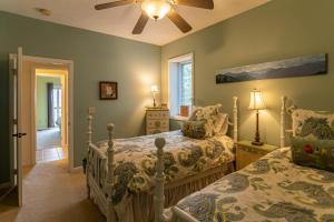 a bedroom with two beds and a ceiling fan at 1 Amazing View in Blowing Rock