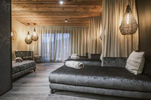 1 Schlafzimmer mit 2 Betten in einem Zimmer mit Holzdecken in der Unterkunft Margarethenstein Boutique Hotel in Kaprun