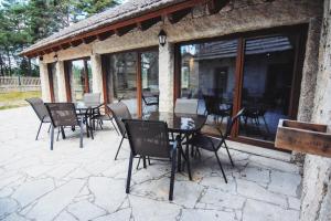 a group of chairs and tables on a patio at Alvão Village & Camping 