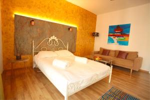 sypialnia z białym łóżkiem i kanapą w obiekcie New Central Luxury Oasis w Klużu-Napoce