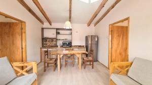 a kitchen and dining room with a table and chairs at Alto Maquehue in Padre Las Casas