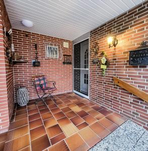 a patio with a bench and a brick wall at Ferienwohnung Meyer in Surwold