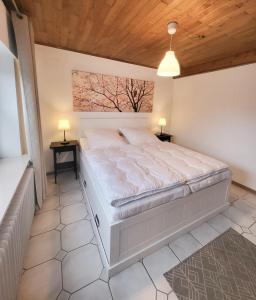 a bedroom with a large bed with two night stands at Ferienwohnung Meyer in Surwold