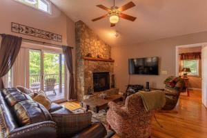 a living room with a couch and a fireplace at Little Bear Lodge in Blowing Rock