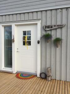 een witte deur aan de zijkant van een huis bij Slow Travel Mývatn - Þúfa - Private Homestay in Myvatn