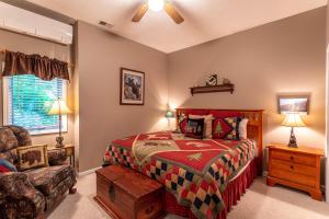 a bedroom with a bed and a chair at Little Bear Lodge in Blowing Rock