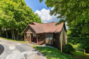 a home in the woods with a driveway at Little Bear Lodge in Blowing Rock