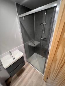a bathroom with a shower and a sink at The Green Man, Eco-friendly cabin in the Lincolnshire countryside with heating and hot water in Lincoln