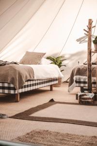 a bedroom with two beds in a tent at Surflogiet Gotland in Tofta
