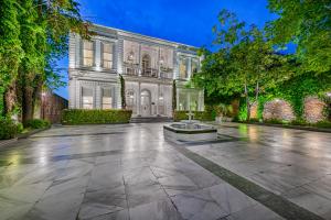 a mansion with a fountain in the middle of a courtyard at Bosphorus Palace Hotel in Istanbul