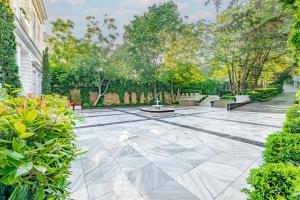 an empty patio with trees and plants in a yard at Bosphorus Palace Hotel in Istanbul