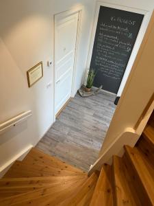 a room with a chalkboard on the wall and a stairway at Slow Travel Mývatn - Þúfa - Private Homestay in Myvatn
