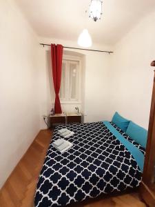 Un dormitorio con una cama en blanco y negro y una ventana en Casa Antica - Historical apartment in old city center, en Trieste