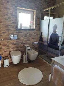 a bathroom with a toilet a sink and a mirror at Alojamento Local Terreiro in Pombal +16 photos