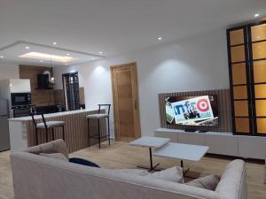 a living room with a couch and a table and a kitchen at Harbor Pond Apartments 2 in Lagos