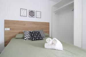 a bedroom with a bed with two towels on it at La maruca loft in Santander