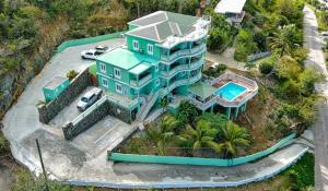 an aerial view of a house with a swimming pool at Wintberg Tropical Villas in Mandal