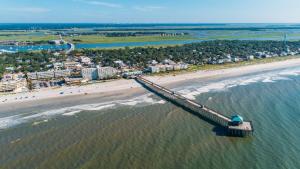 an aerial view of a beach with a pier at Island Hideout in Charleston