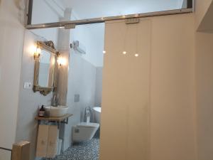 a bathroom with a shower with a toilet and a sink at EL HECHIZO DEL BAILÓN in Zuheros