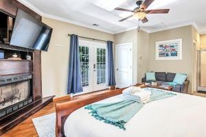 a bedroom with a large bed and a fireplace at Island Nest in Charleston