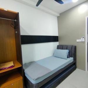a small room with a bed in it at SiX Staycation in Kuching
