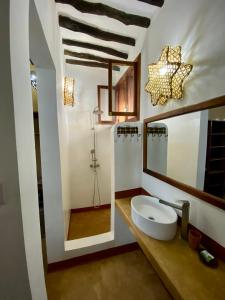 a bathroom with a sink and a mirror at Zuzanu house in Nungwi