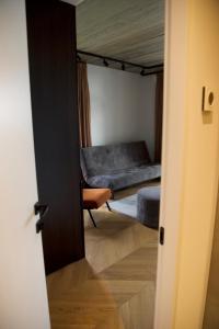 a door open to a bedroom with a bed at J. Ralio apartamentai in Vilnius