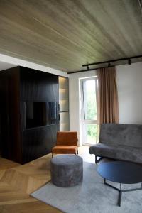 a living room with a couch and a tv at J. Ralio apartamentai in Vilnius
