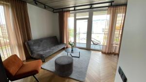 a living room with a couch and a table at J. Ralio apartamentai in Vilnius