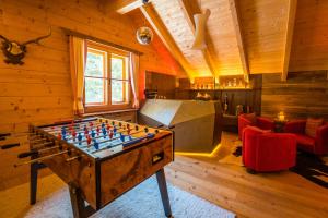 a room with a foosball table in the middle of a room at Bergchalet Kuhgraben in Bad Sankt Leonhard im Lavanttal