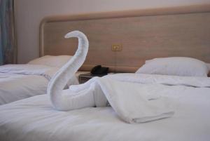 a swan made out of towels on a bed at Acacia Dahab Hotel in Dahab