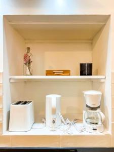 a shelf with a coffee maker and cups on it at Nouveau * L’élégant au cœur de Guingamp * in Guingamp
