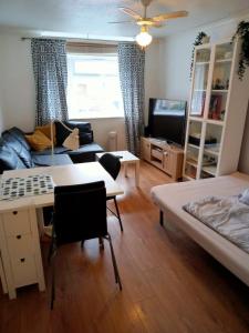 a living room with two beds and a couch at The beautiful corner of Copenhagen close in Luton