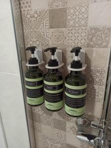 two bottles of soap sitting on a shelf next to a sink at Apartamento Premium PLAZA MAYOR con PARKING in Avila +26 photos