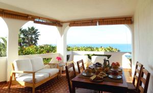 a table and chairs on a balcony with the ocean at Le Case di Concetta in Santa Maria