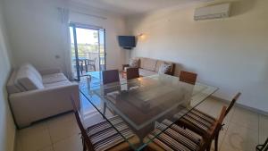 a living room with a glass table and a couch at Quinta do Pinheiro Premium by Sunny Deluxe in Olhos de Água