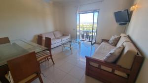 a living room with a couch and a table at Quinta do Pinheiro Premium by Sunny Deluxe in Olhos de Água