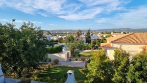 a view of a yard with trees and buildings at Quinta do Pinheiro Premium by Sunny Deluxe in Olhos de Água