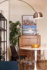a dining room with a table and a lamp at Marina Zeas apartment by the sea in Piraeus