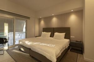 Łóżko lub łóżka w pokoju w obiekcie Über Lux 2 BR New Penthouse with Acropolis View