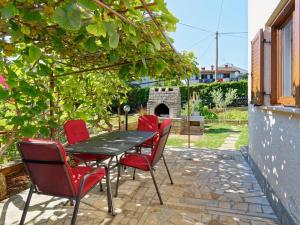 stół i krzesła na patio z kominkiem w obiekcie Apartments Marta w mieście Novigrad