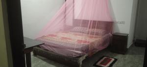 a bedroom with a bed with a mosquito net at Senu Home in Weligama