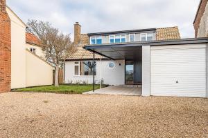 a house with a garage and a brick building at Chapel House in Woodbridge