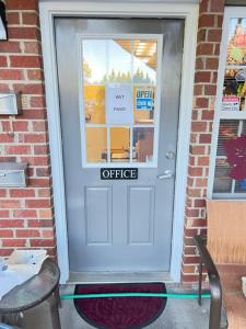 a white door with an office sign on it at Eastside Suites in Lynchburg