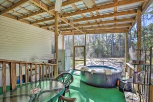 a patio with a hot tub on a deck at Keaton Beach Escape with Hot Tub 2 Mi to Shore in Perry
