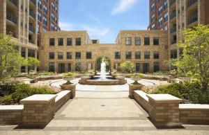 a courtyard with a fountain in front of a building at Splendid 2 BR Condo At Pentagon City in Arlington